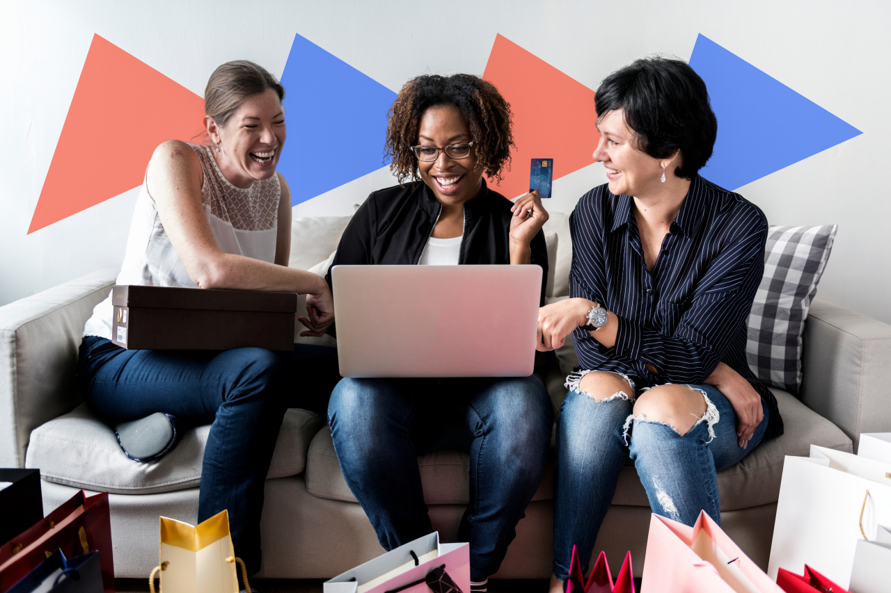 Three women shopping online together with a laptop and shopping bags, highlighting a social buying experience and upsell opportunity.