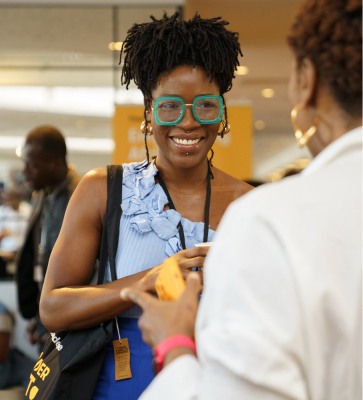 Lady smiling and talking to another