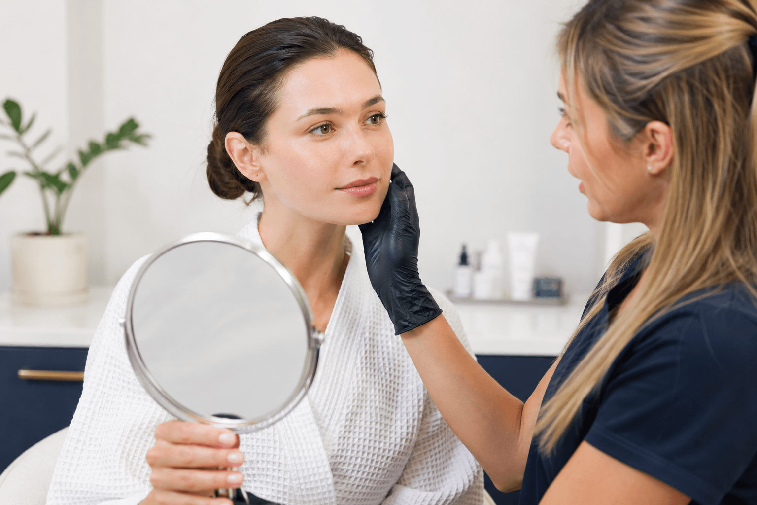 Aesthetic provider evaluating a patient's skin before a SkinPen microneedling treatment in McMurray, Pennsylvania.