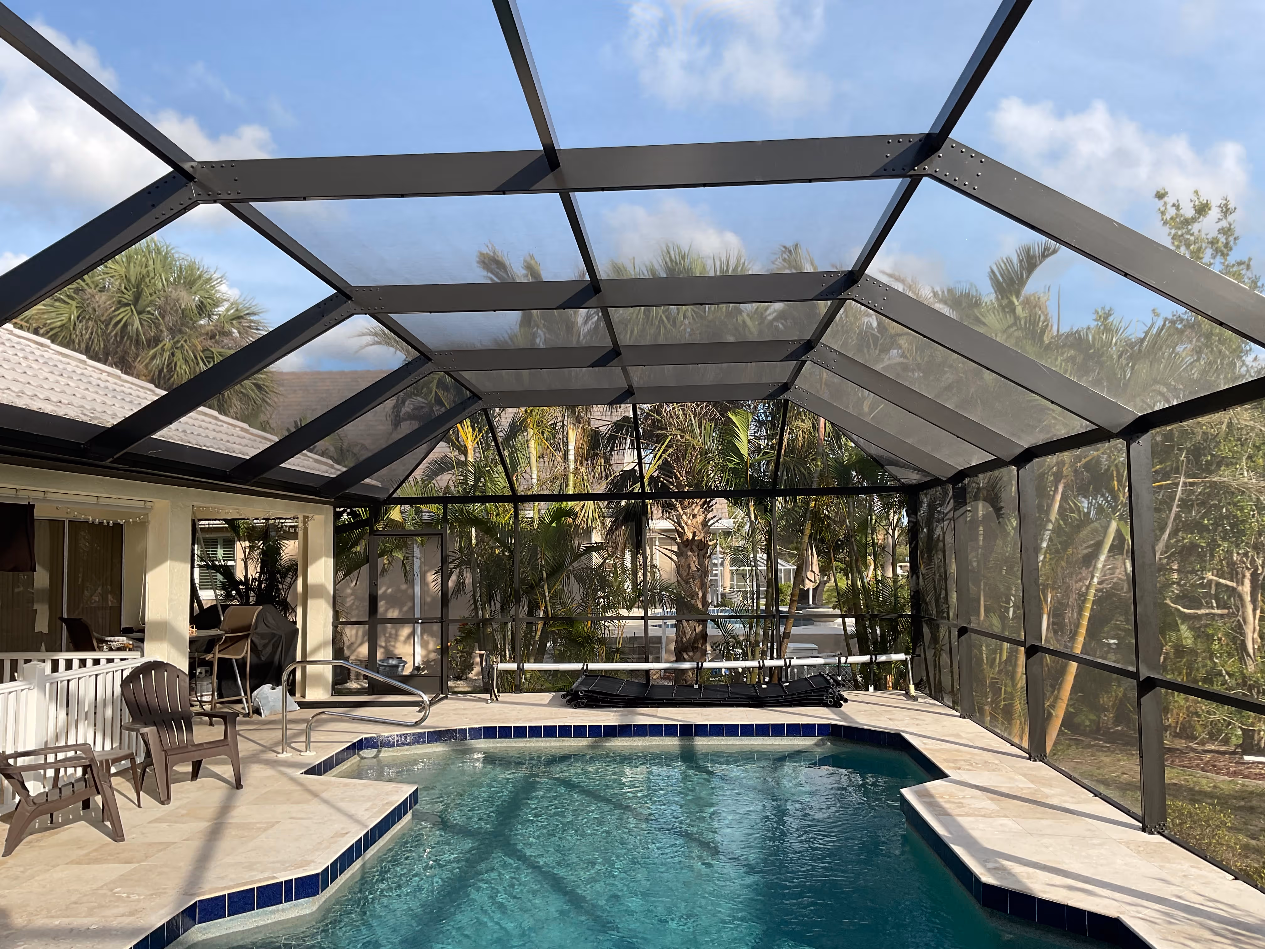 Pool enclosure with white aluminum frame and screened panels — AB Aluminum & Screens