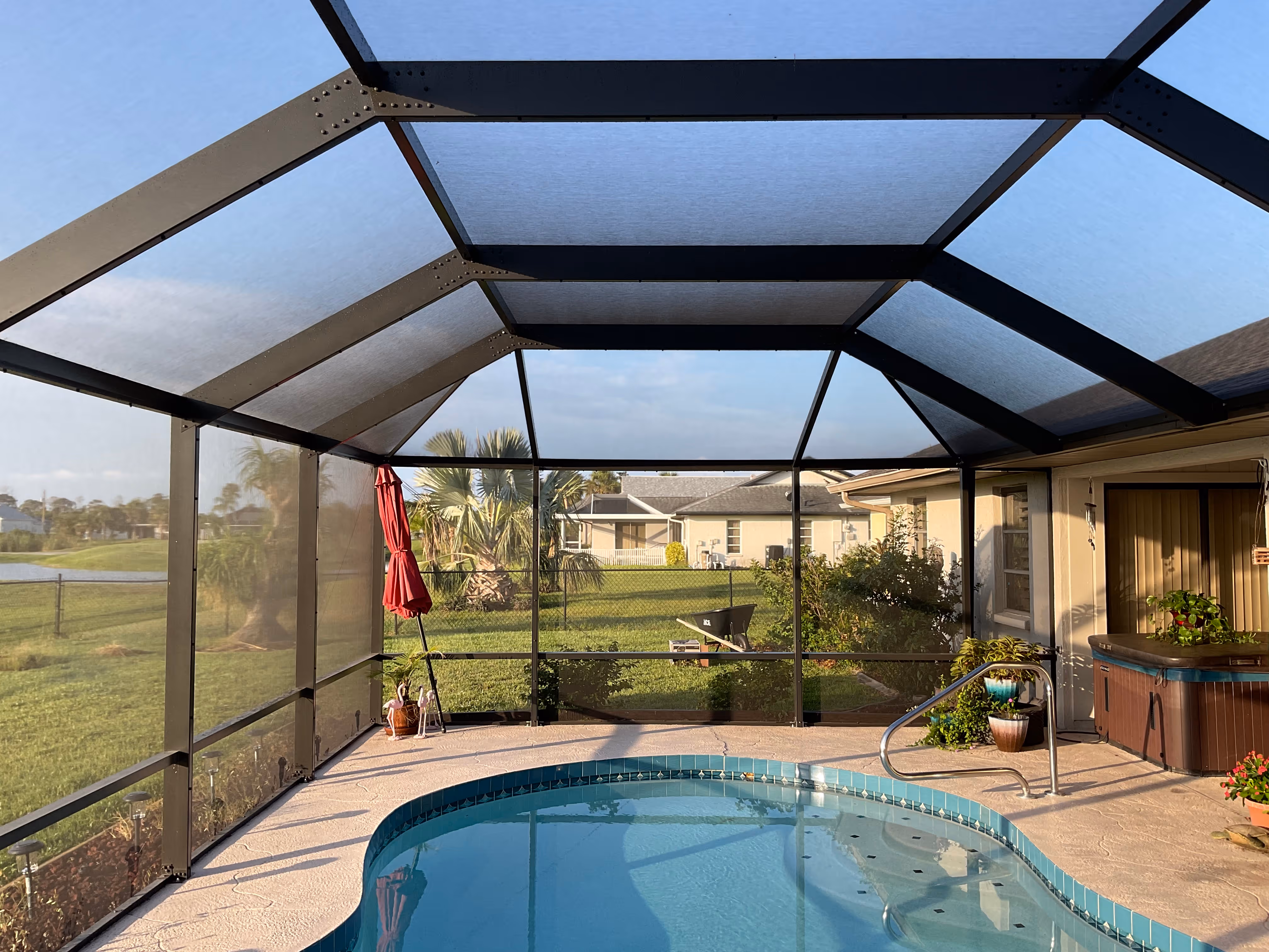 Wide-angle view of pool screen enclosure South Florida home — AB Aluminum & Screens