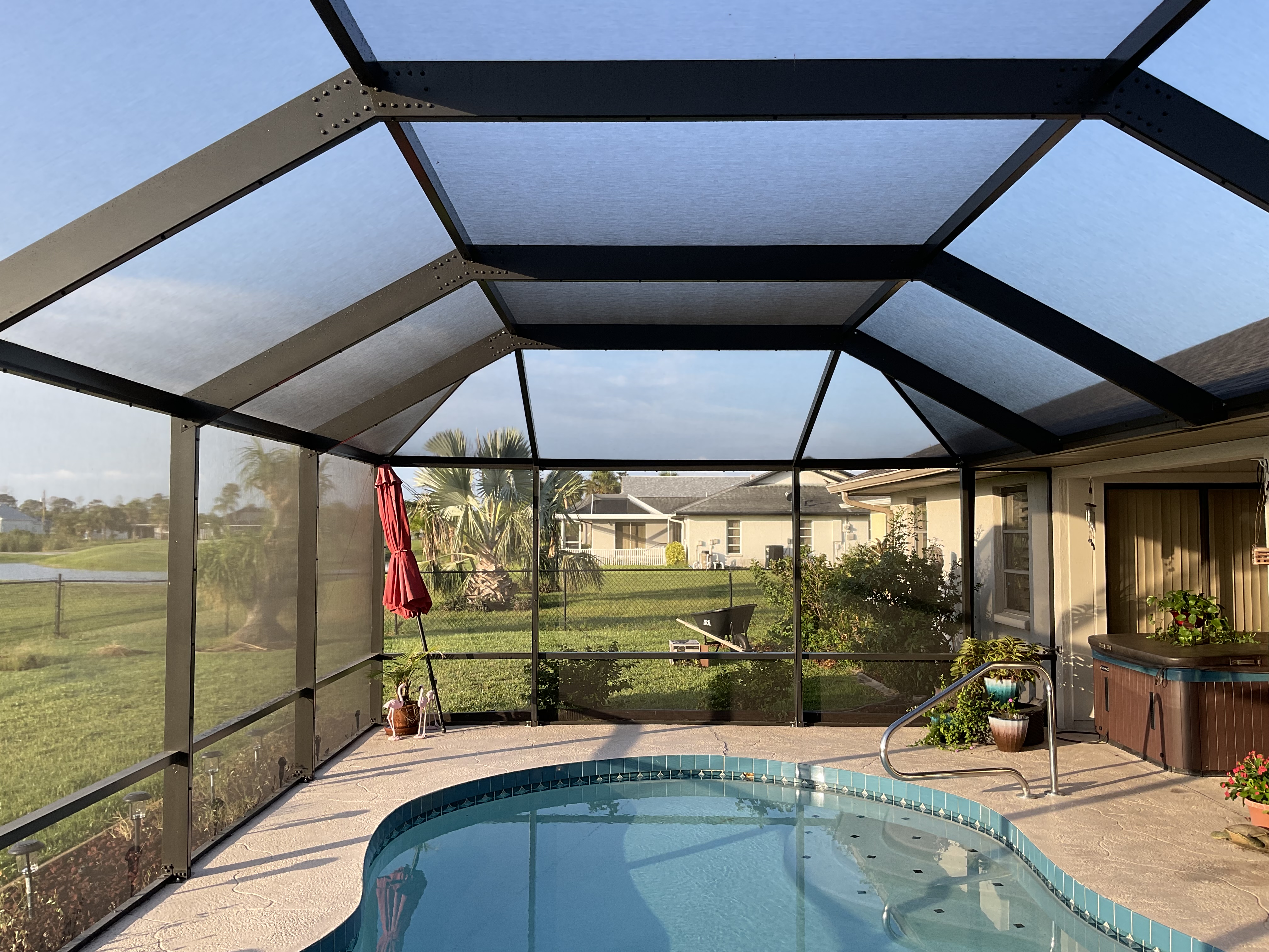 Wide-angle view of pool screen enclosure South Florida home — AB Aluminum & Screens