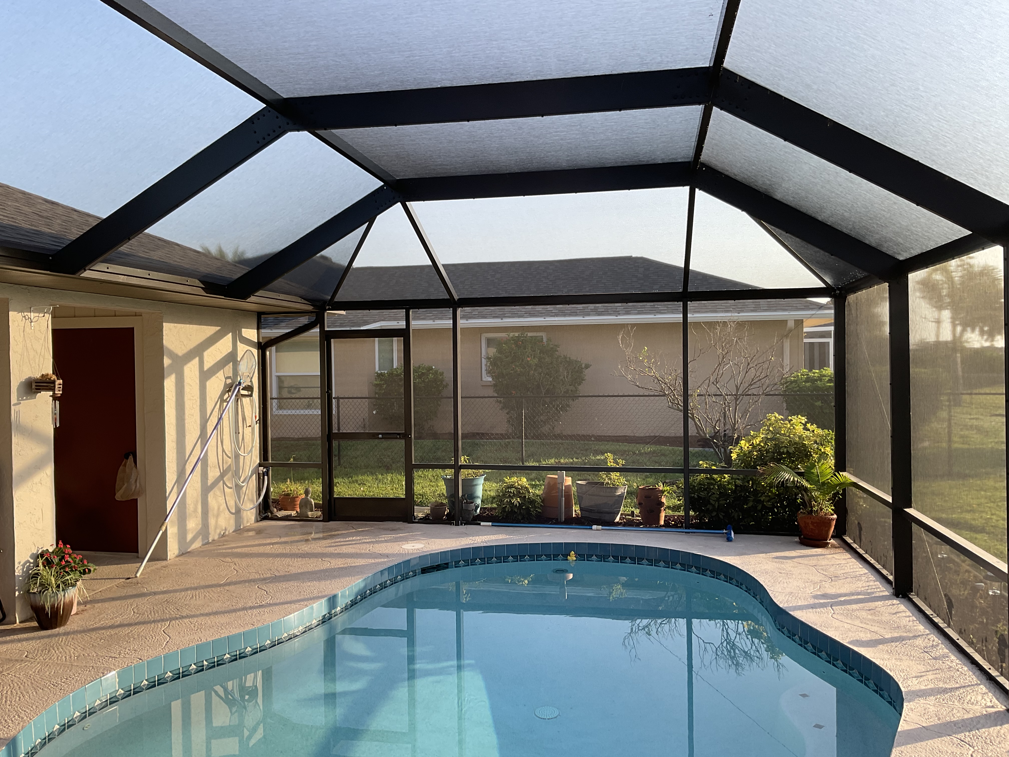 Pool cage installation suburban home backyard Miami-Dade — AB Aluminum & Screens