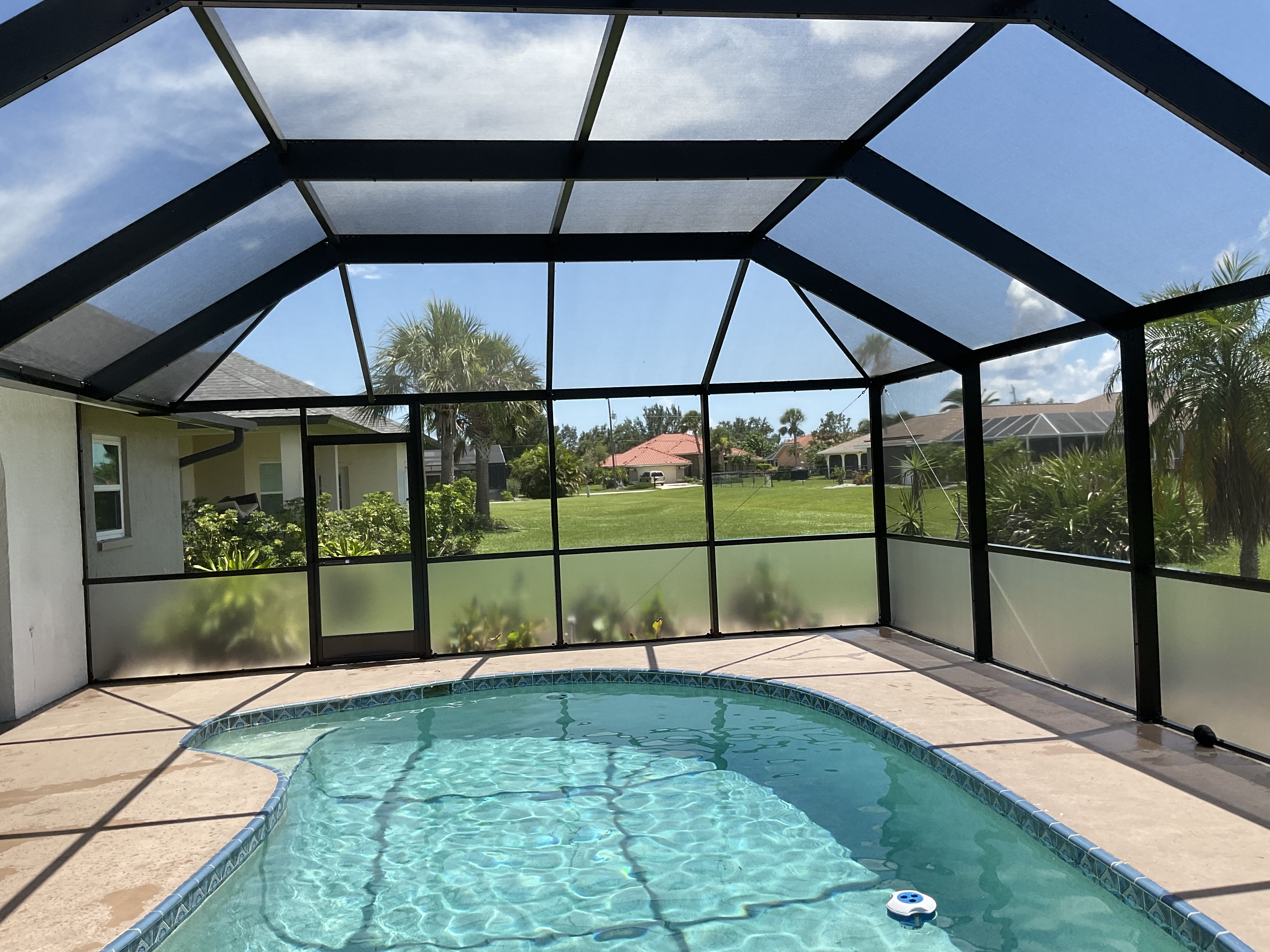 Pool cage with aluminum hip roof style South Florida — AB Aluminum & Screens