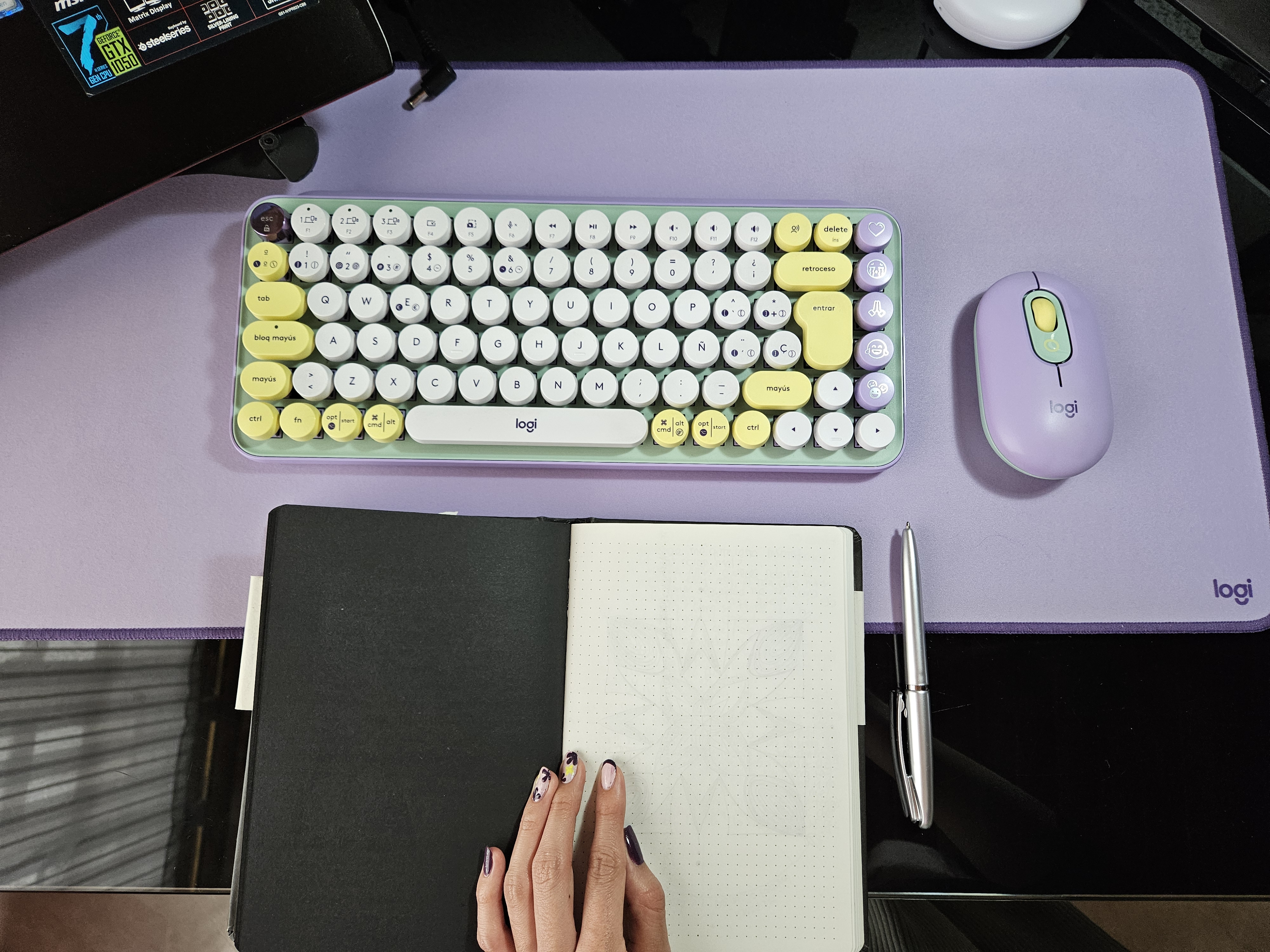 a photo of a keyboard, mouse and a journal