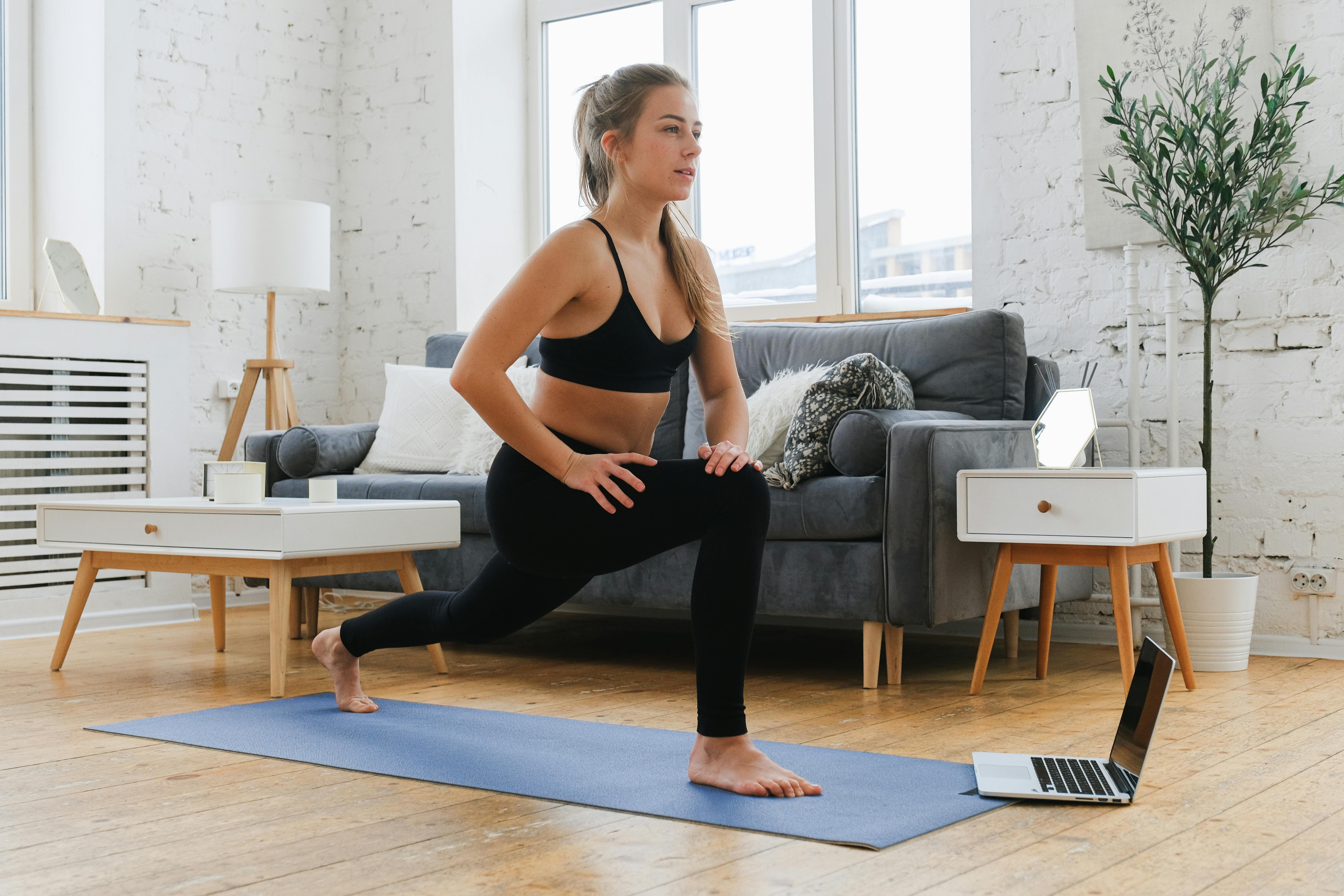 A person exercising with a laptop nearby, showcasing the important of beats to workout content.