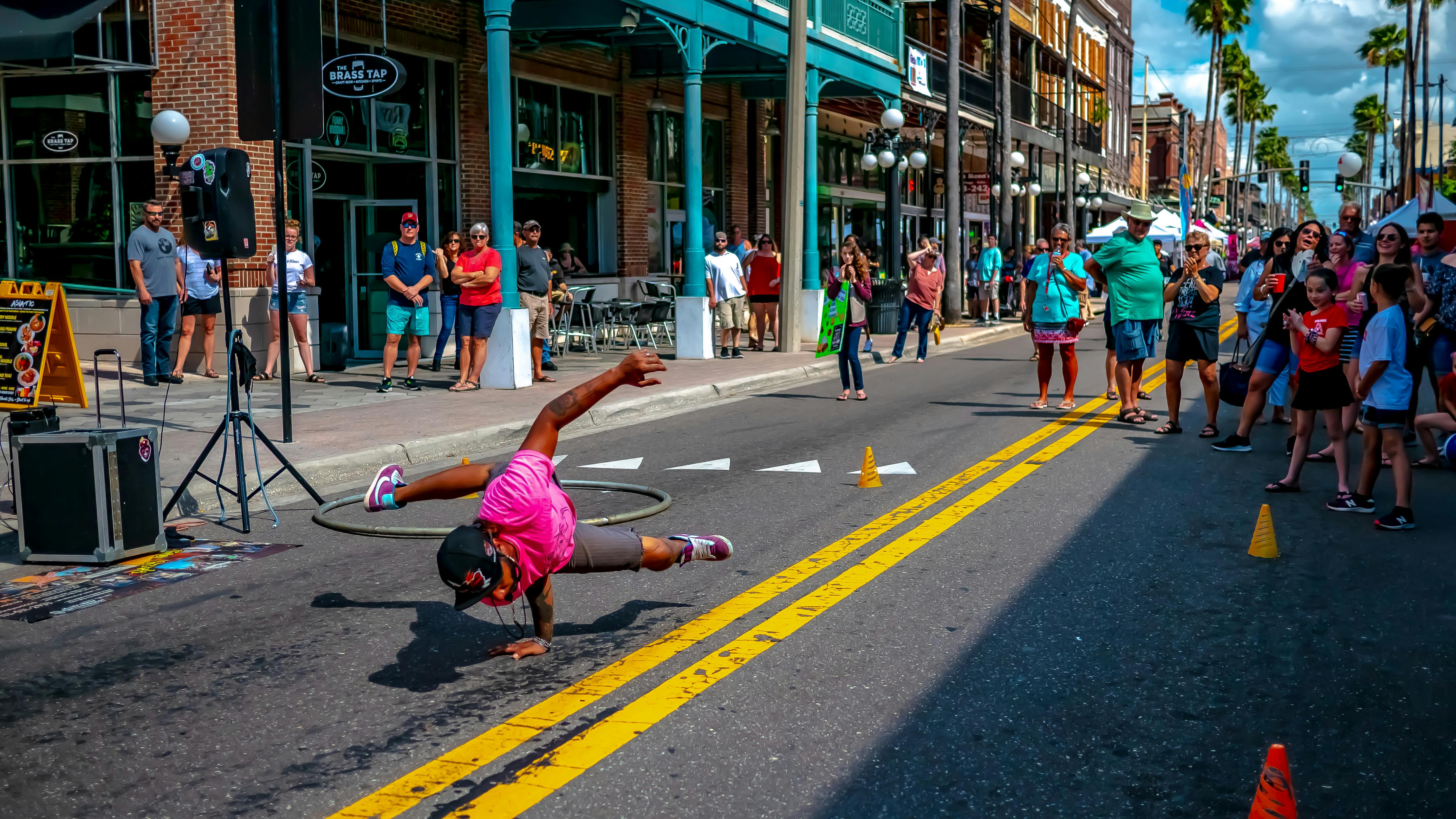 A breakdancing performance at a block party - this represents defining points in hip-hop culture.