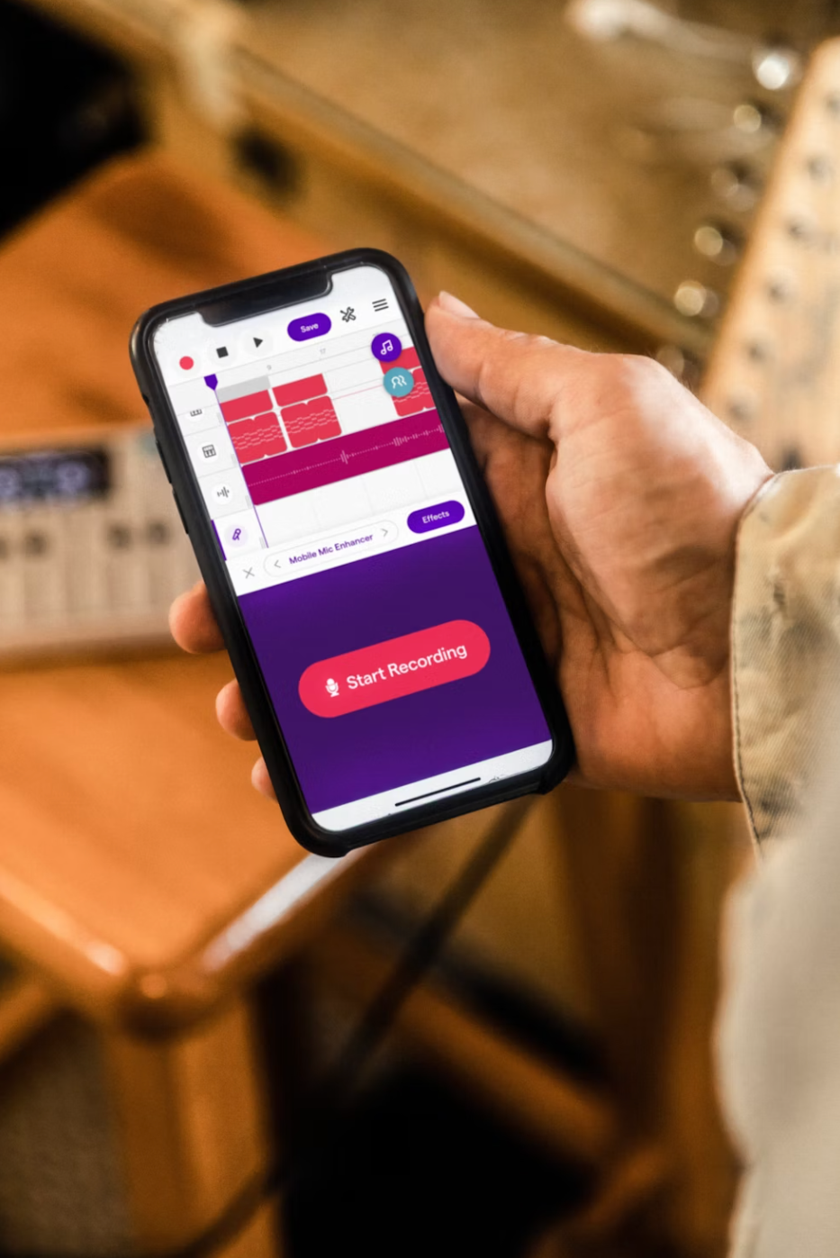 A person recording and editing music on their phone via an app, representing the new ease of mobile music production.