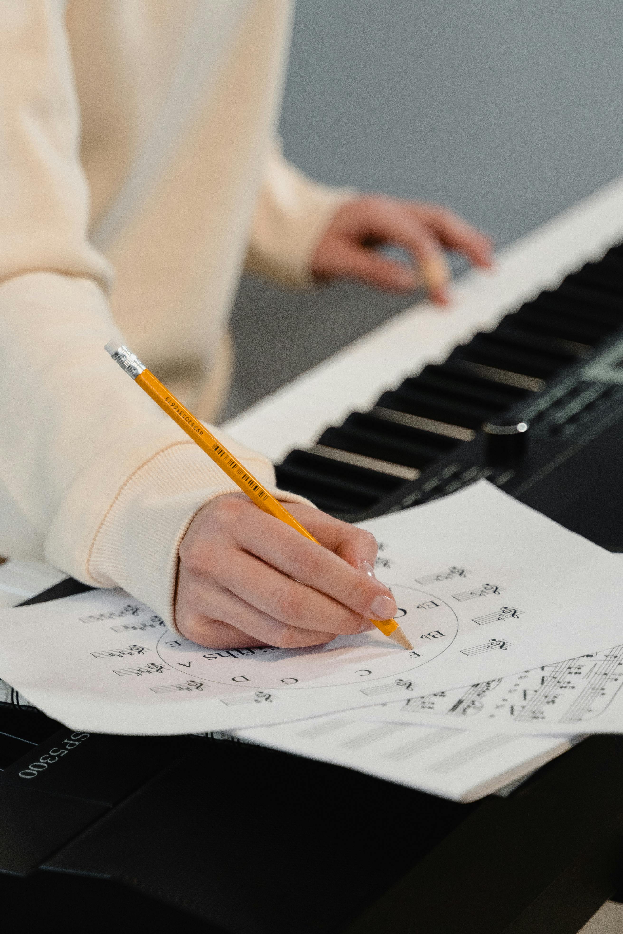 An artist working on sheet music, representing songwriting.