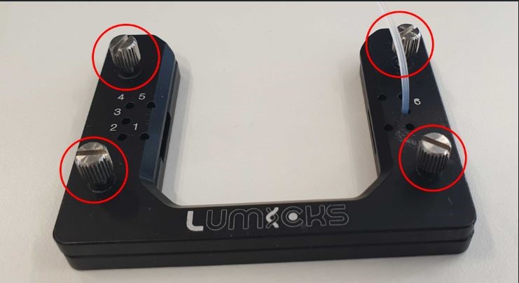 A black device with red circlesDescription automatically generated