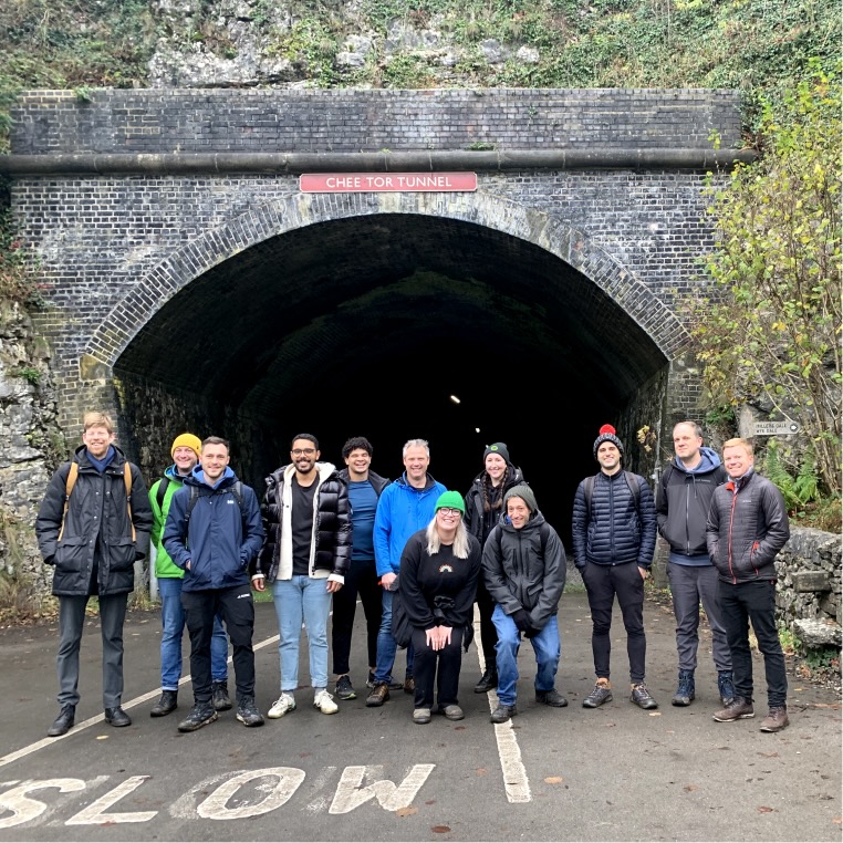 A group of Ubio employees posing in front of a foot tunnel