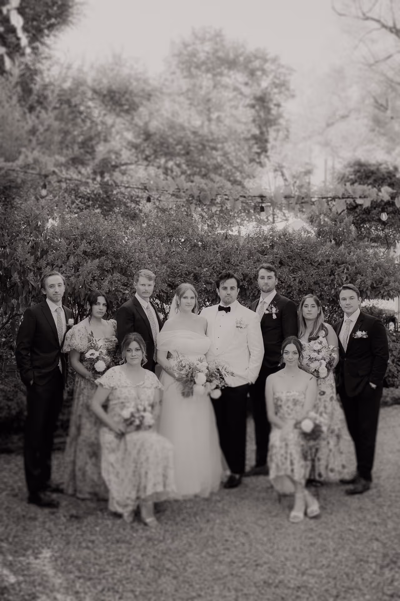 Black and white portrait of the wedding party in the garden at a fall M and D Farm wedding