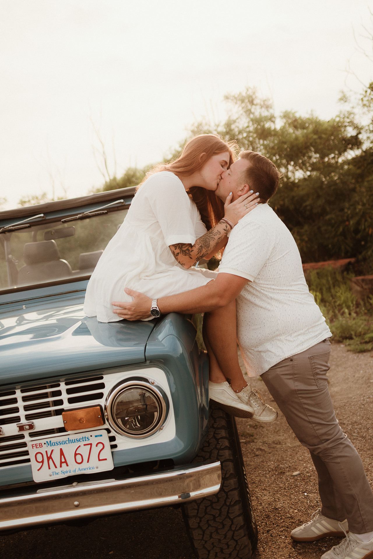 Couple kissing against a vintage pickup truck during a Marblehead engagement session