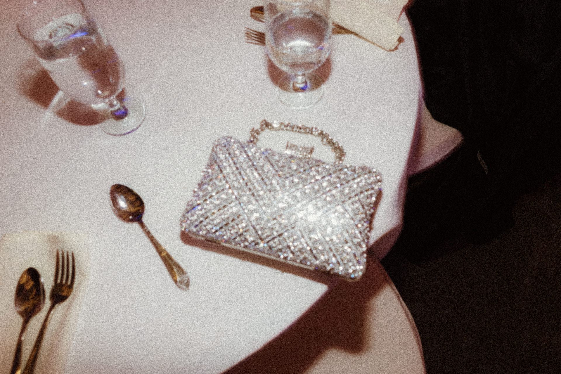 Beaded clutch and champagne glasses on a reception table at Glen Sanders Mansion