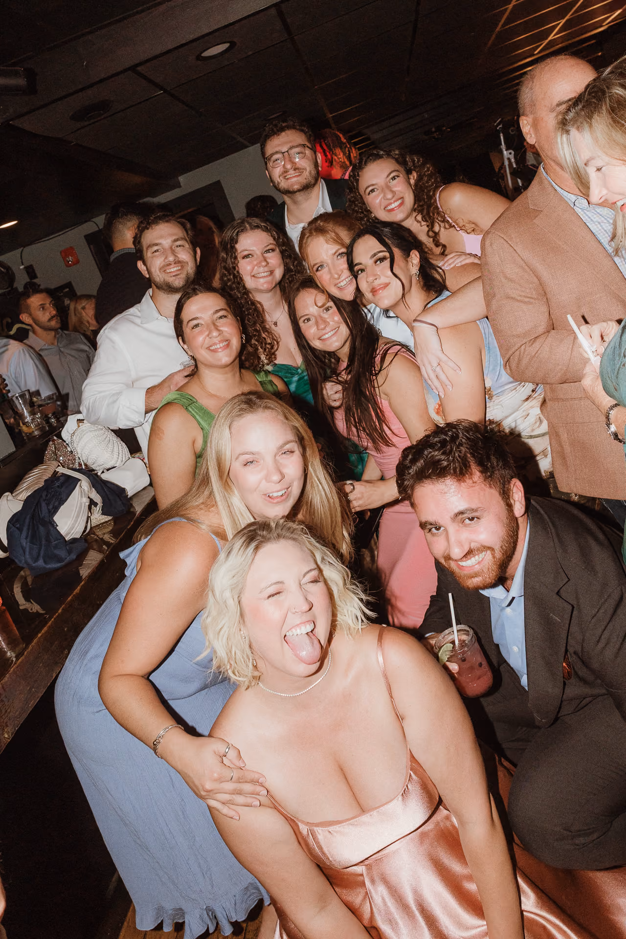 Guests crowding together laughing at a welcome party