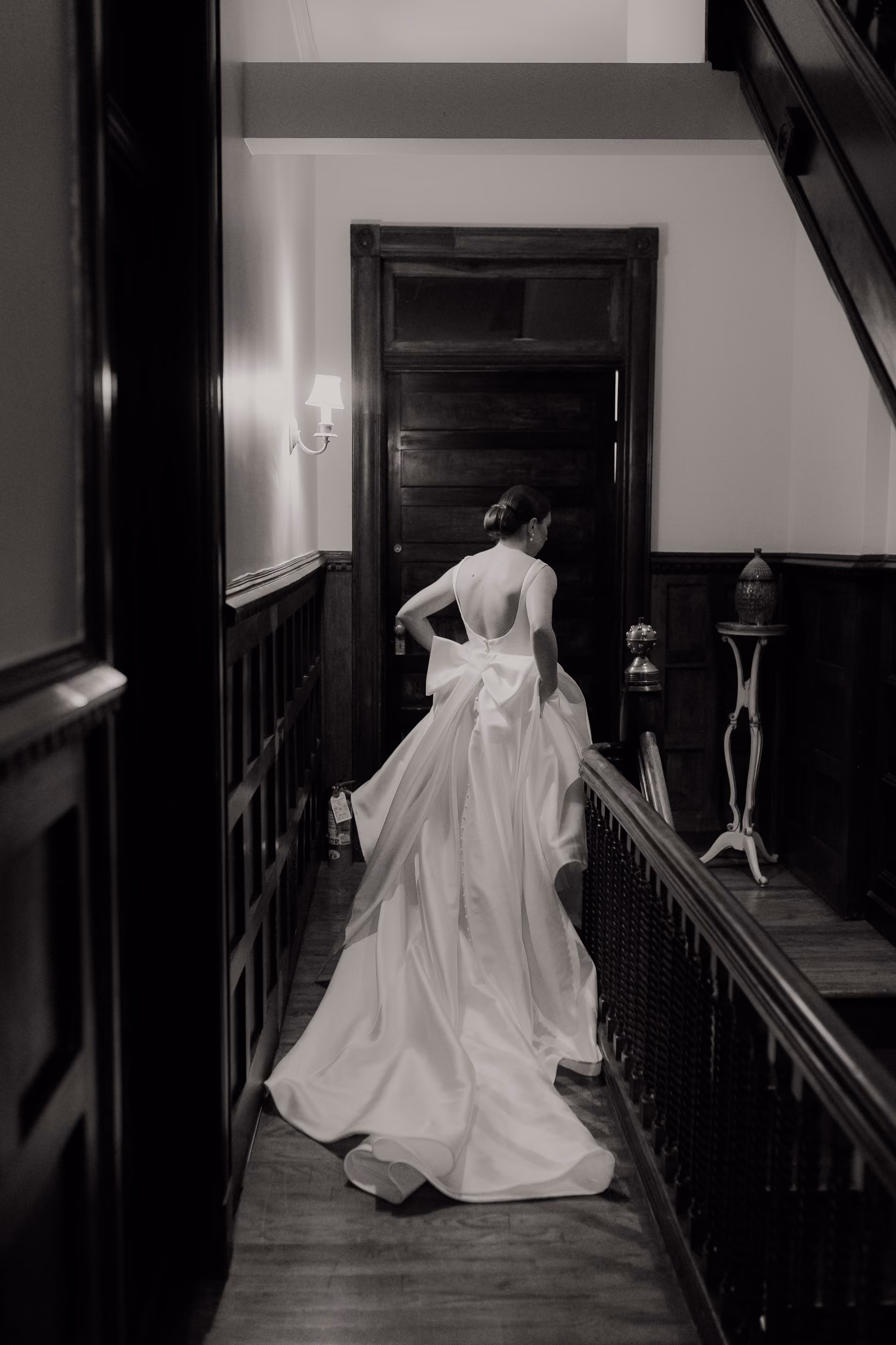 Black and white photograph of a bride and groom kissing beneath her veil at Glen Sanders Mansion