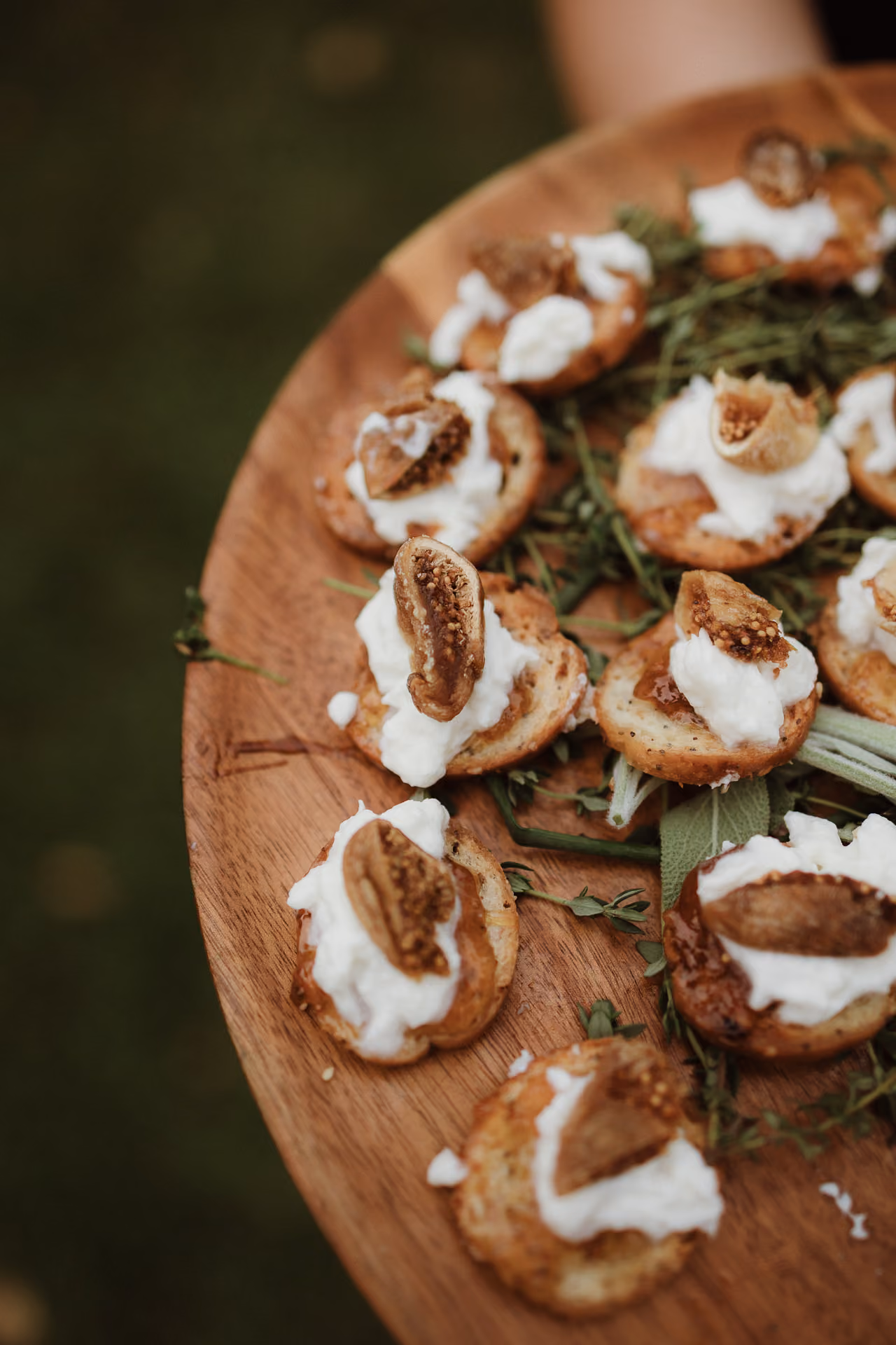 Fig and goat cheese canapés on a wooden board at Windrift Hall
