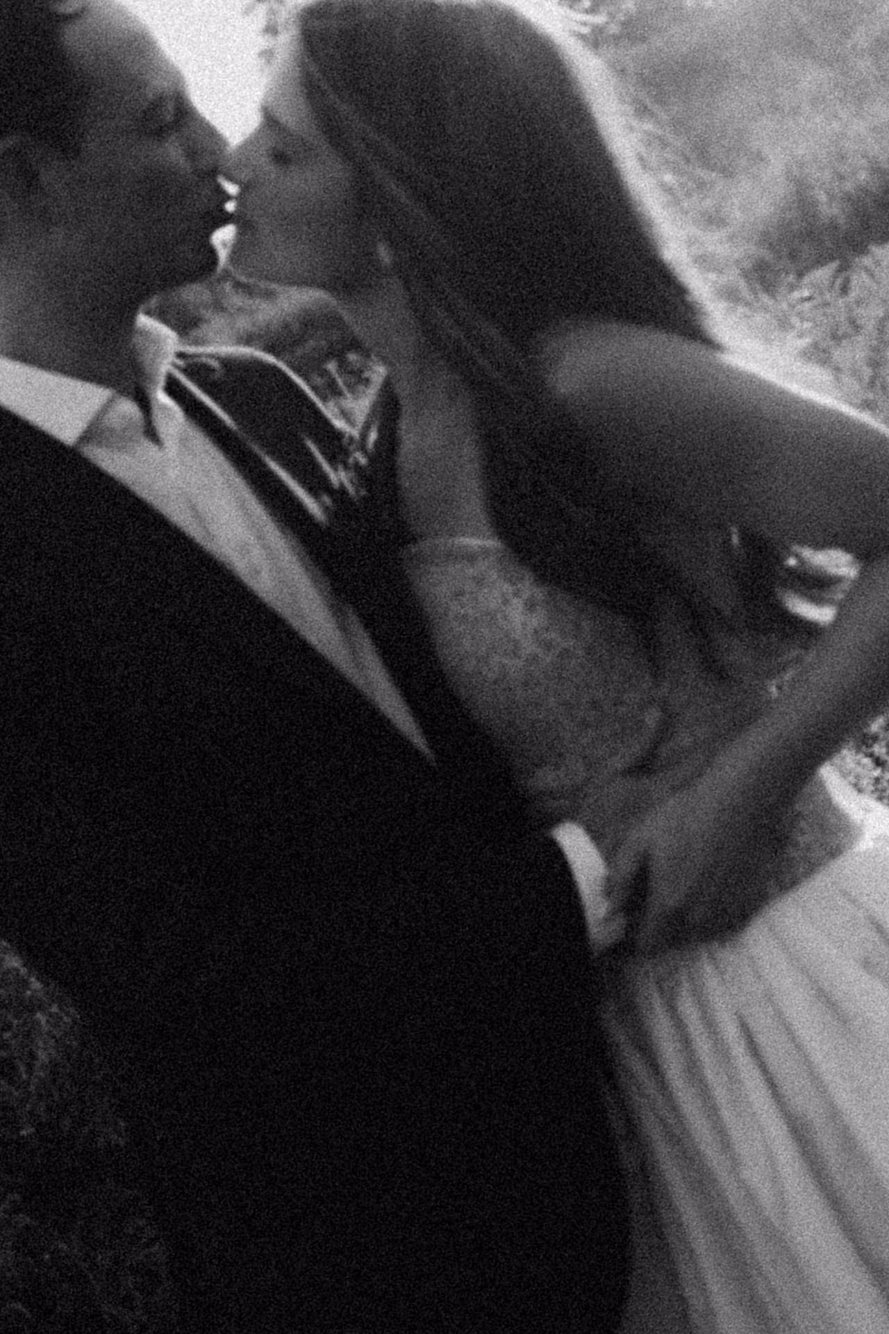 Black and white photograph of a couple kissing at a Camptown welcome party