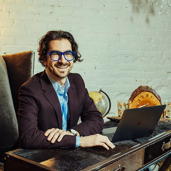 Brian Miller smiling wearing glasses