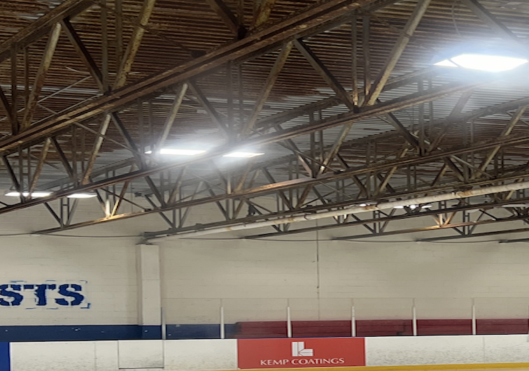 a Kemp Coating advertising banner in a hockey ring