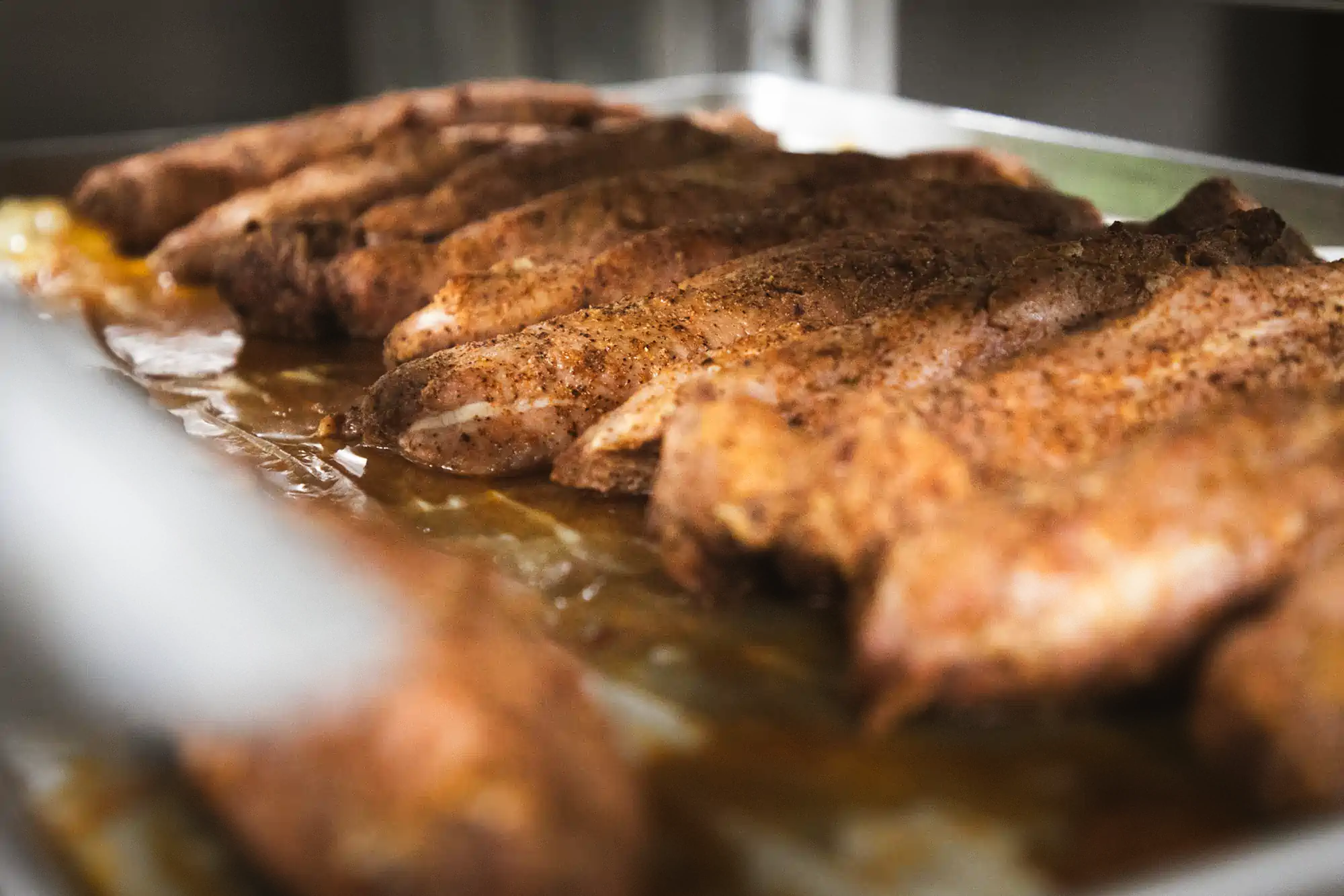 A tray of seasoned, cooked chicken breasts from Fed by Jed's meal prep and delivery service in Milwaukee.