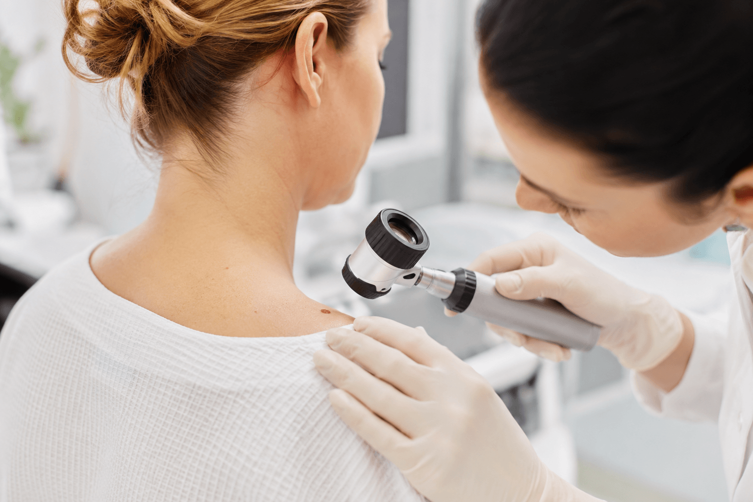 Dermatologist examining a suspicious basal cell carcinoma lesion for Skin Cancer Removal in Monroe, Georgia