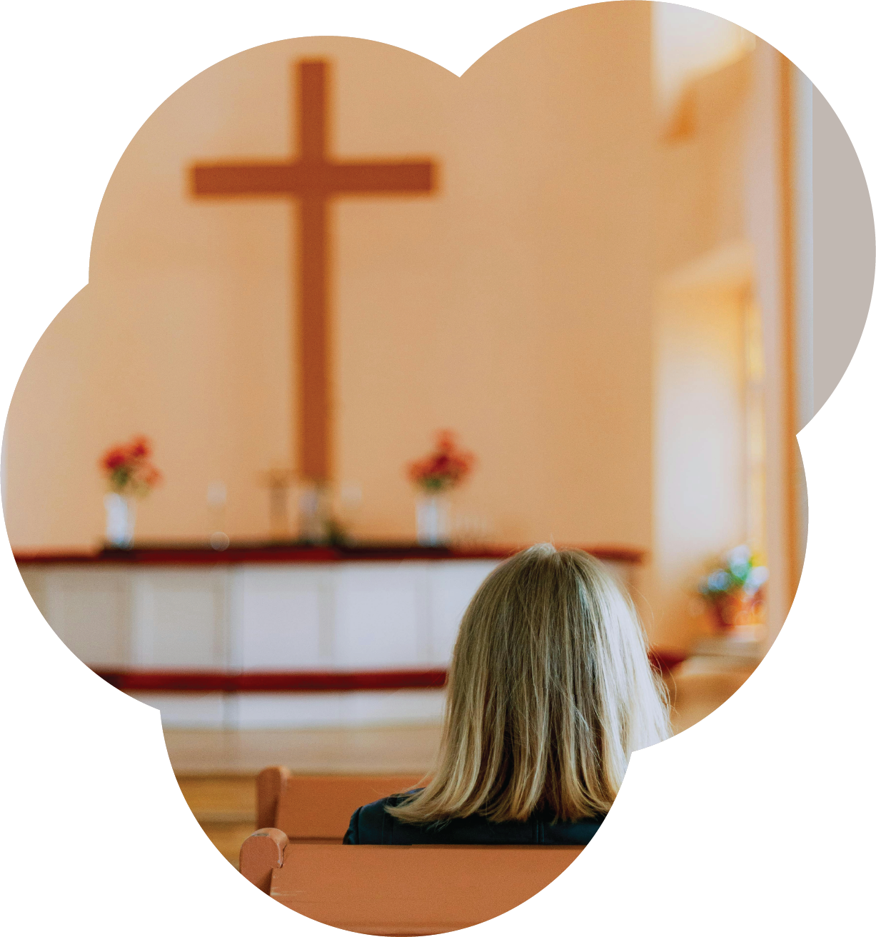 Image of person sitting in church. Photo by DNK.PHOTO on Unsplash