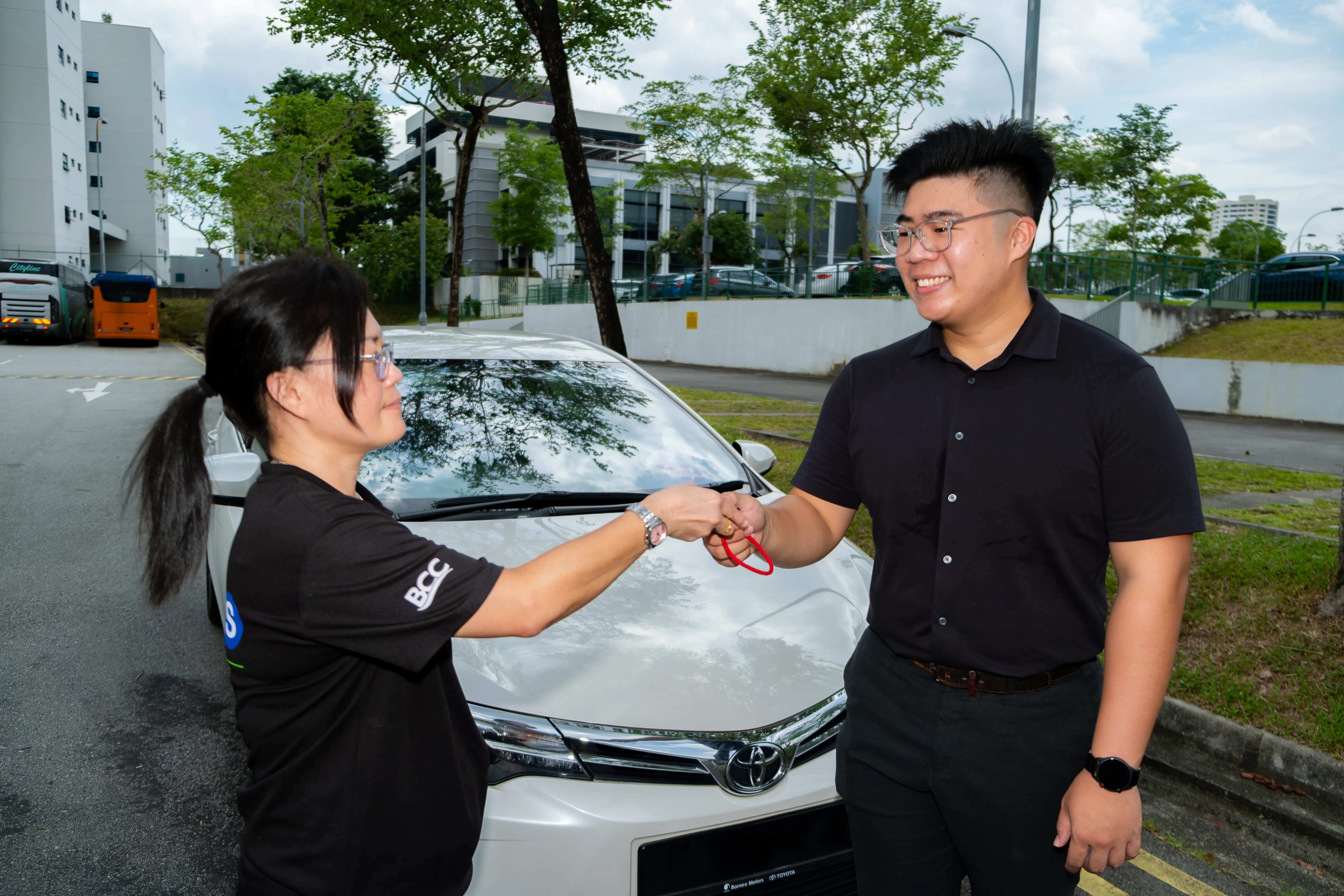 Image of staff handing key to customer