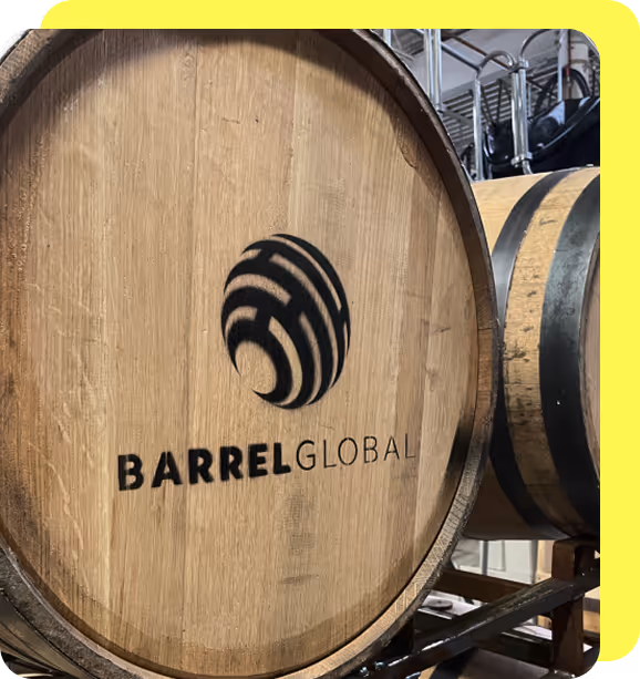 Wooden barrel with the Barrel Global logo painted in black on the front.