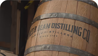 Wooden barrel with metal bands labeled W.S.B. Team Distilling Co. family distillers since 1786.