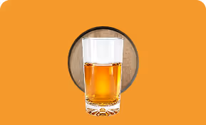 Transparent glass filled halfway with an amber liquid on an orange background with a circular wood texture behind.