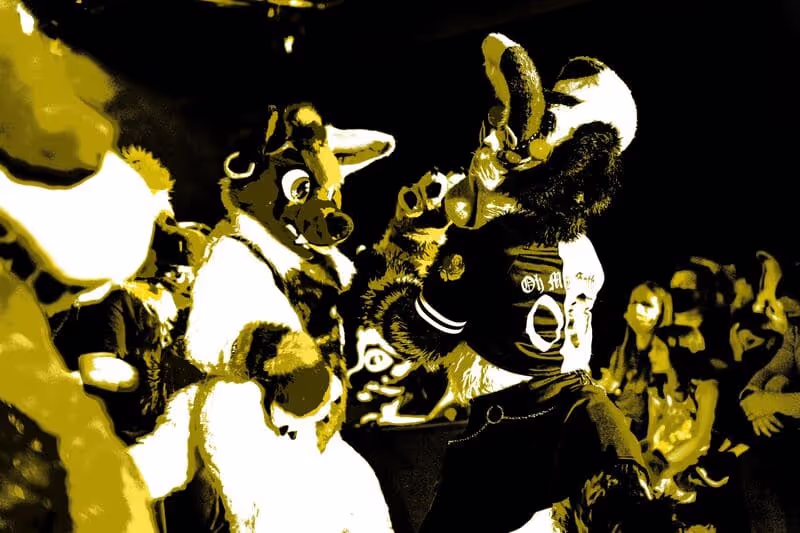 Two fursuiters grooving at the dance party. Photo by SleepyDef.