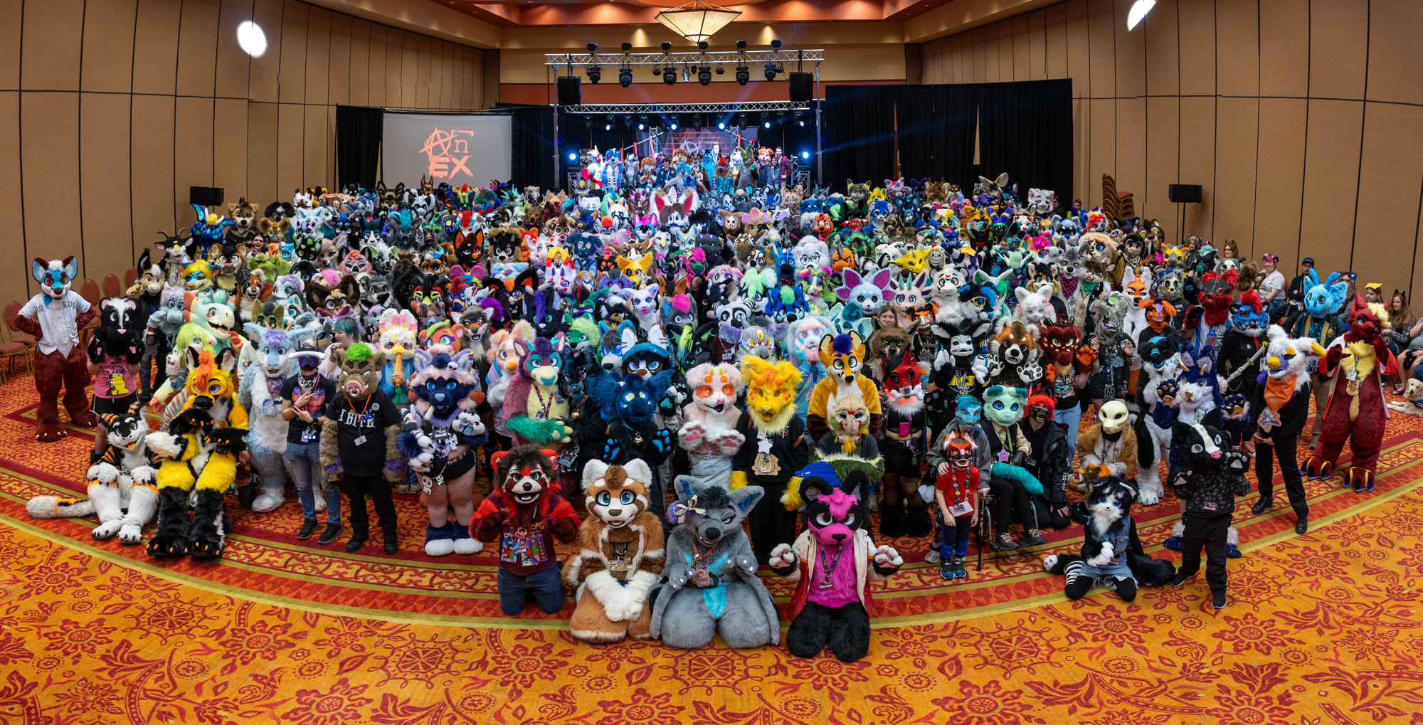 Group photo of 329 fursuiters in the Main Events room.