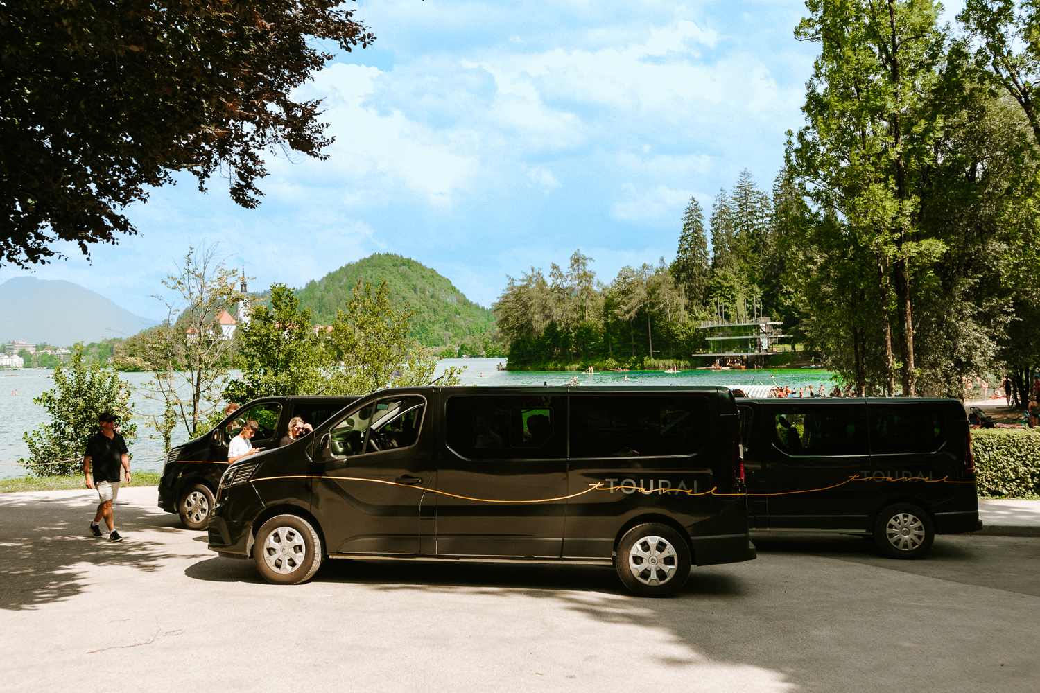 Three modern Toural Travel mini vans ready to transport tourists to the stunning Lake Bled, one of Slovenia’s top attractions. Enjoy a comfortable, safe, and scenic journey with a trusted local tour company.