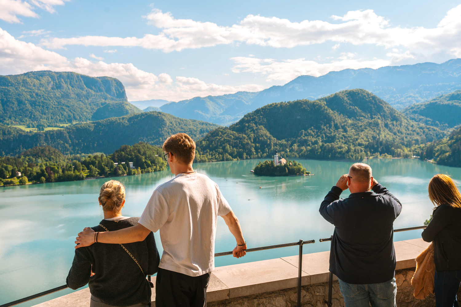 Tourists take in stunning views of Lake Bled from the historic Bled Castle, a must-see attraction in Slovenia.