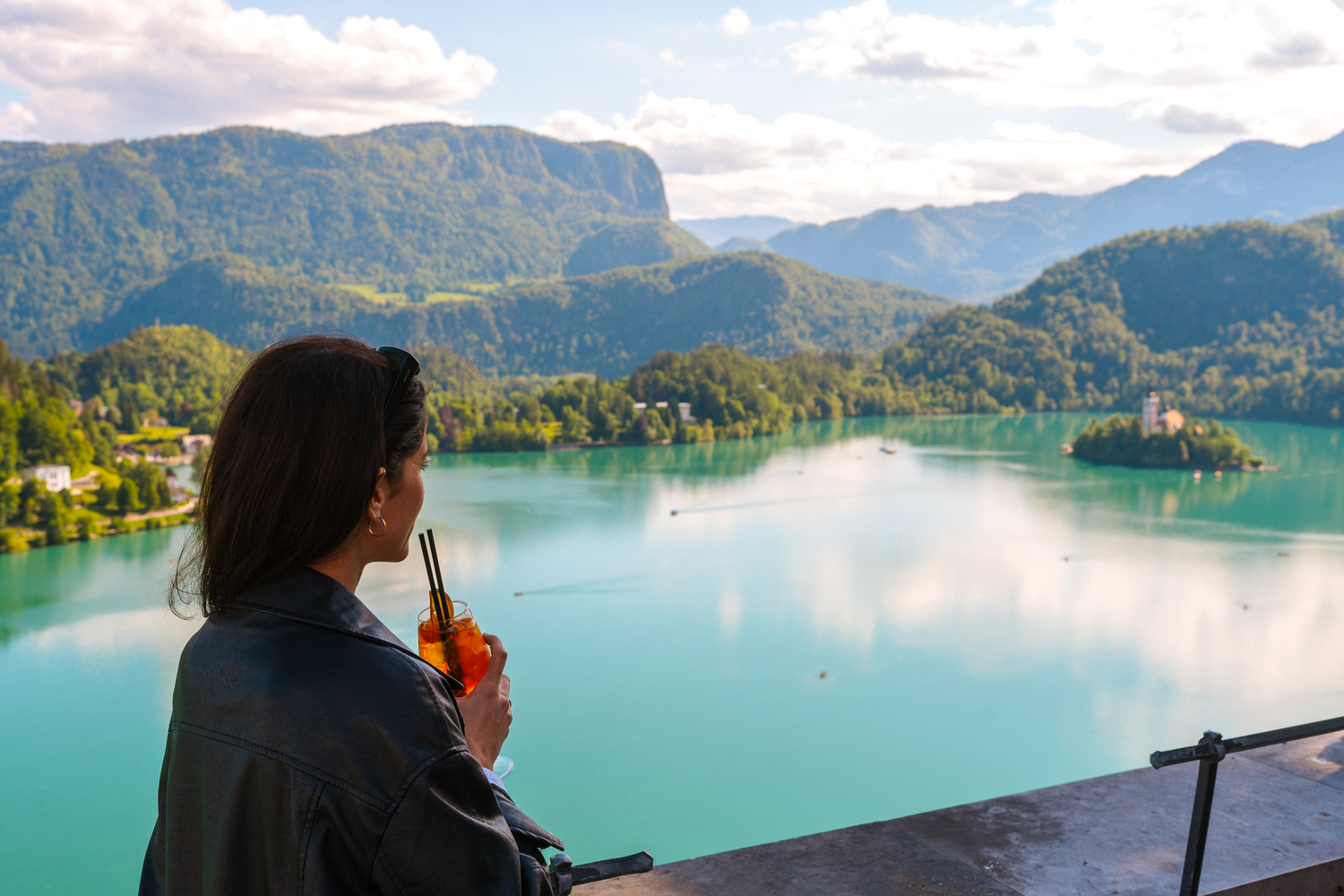 Tourists take in the stunning views of Lake Bled from the historic Bled Castle, a must-see attraction in Slovenia and Europe.