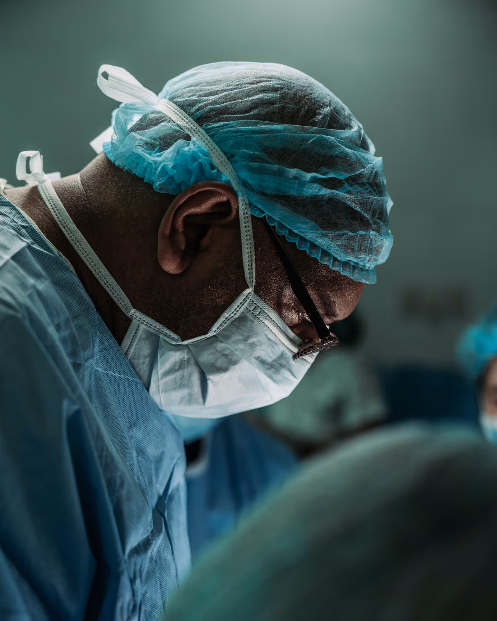 A close up image of a surgeon looking at his patient intently, carerev brand