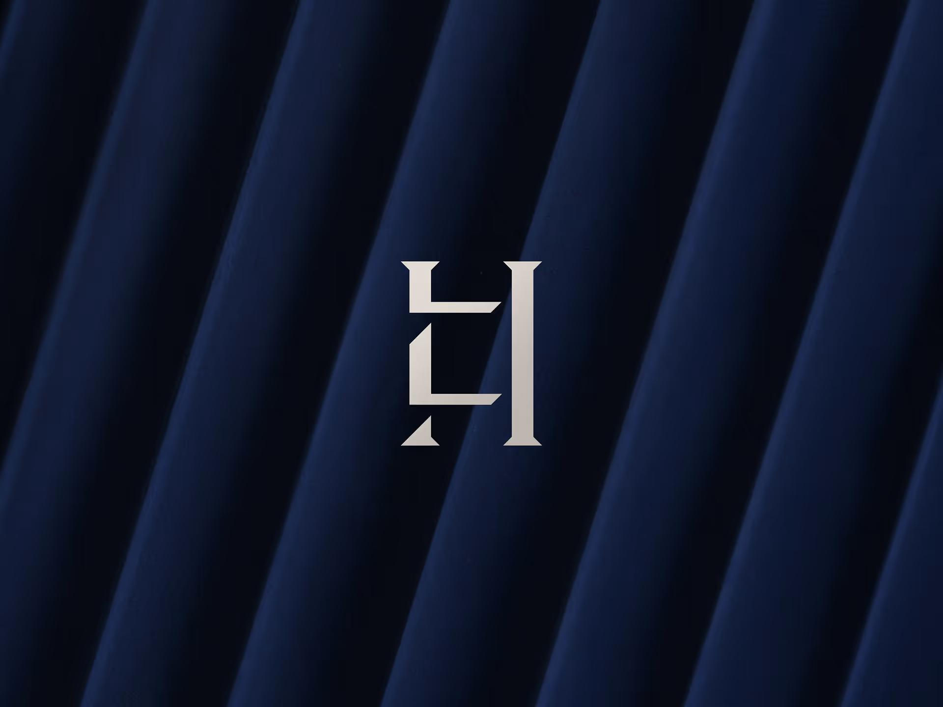 Stylized white monogram resembling the letters H and L on a dark blue textured diagonal striped background.