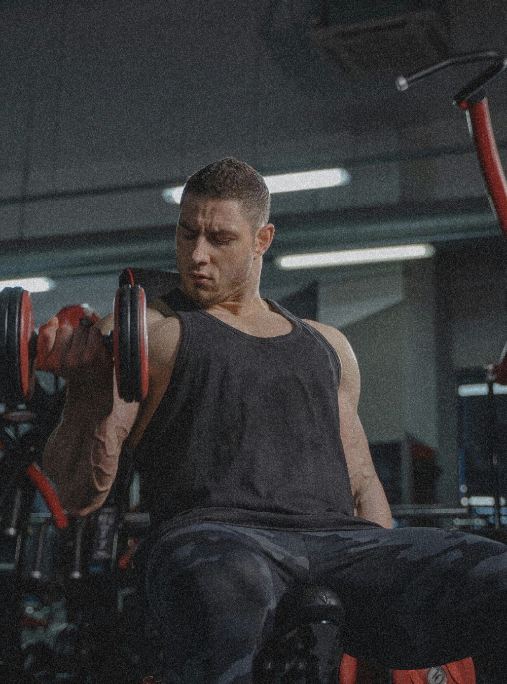 a strong men  carrying dumbells