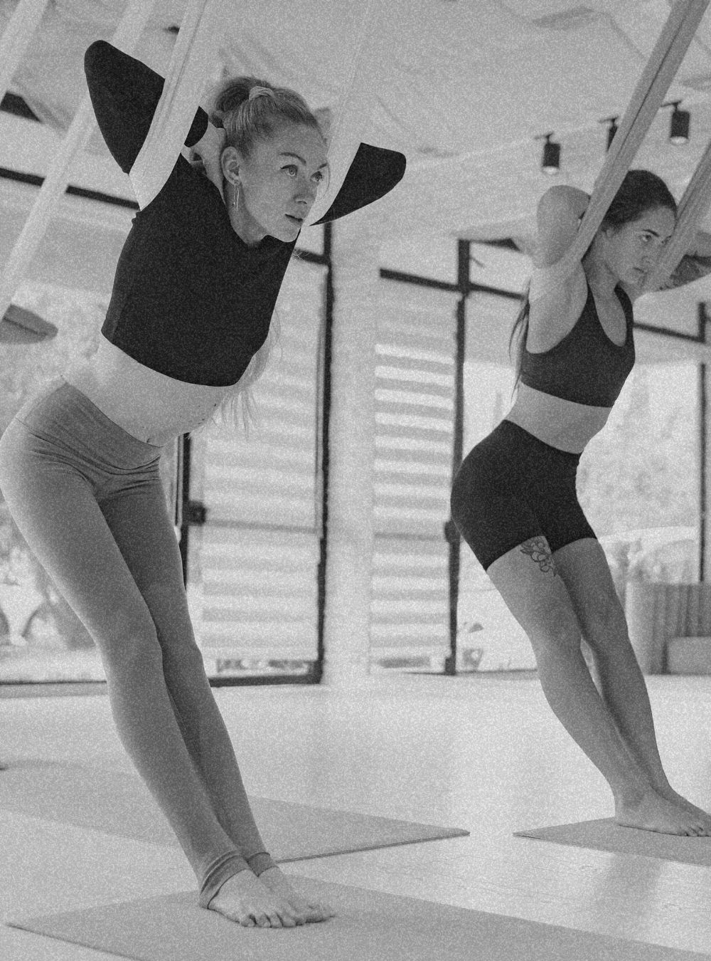 women doing swing yoga dark mode picture