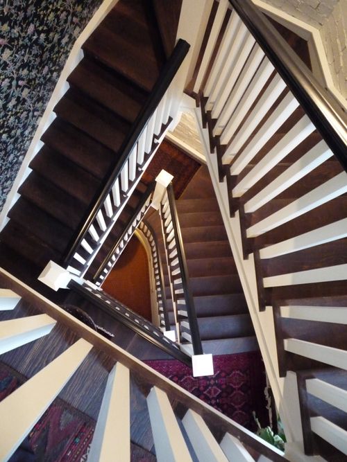 Birds eye view of a traditional timber staircase winding its way down a multi level home