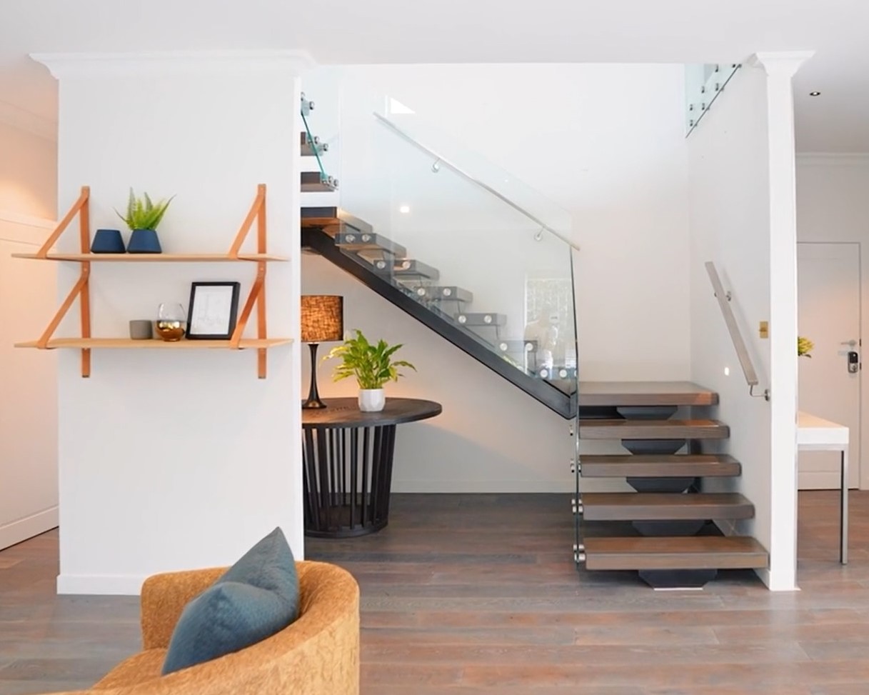 modern floating stairs positioned in a bright, airy alcove