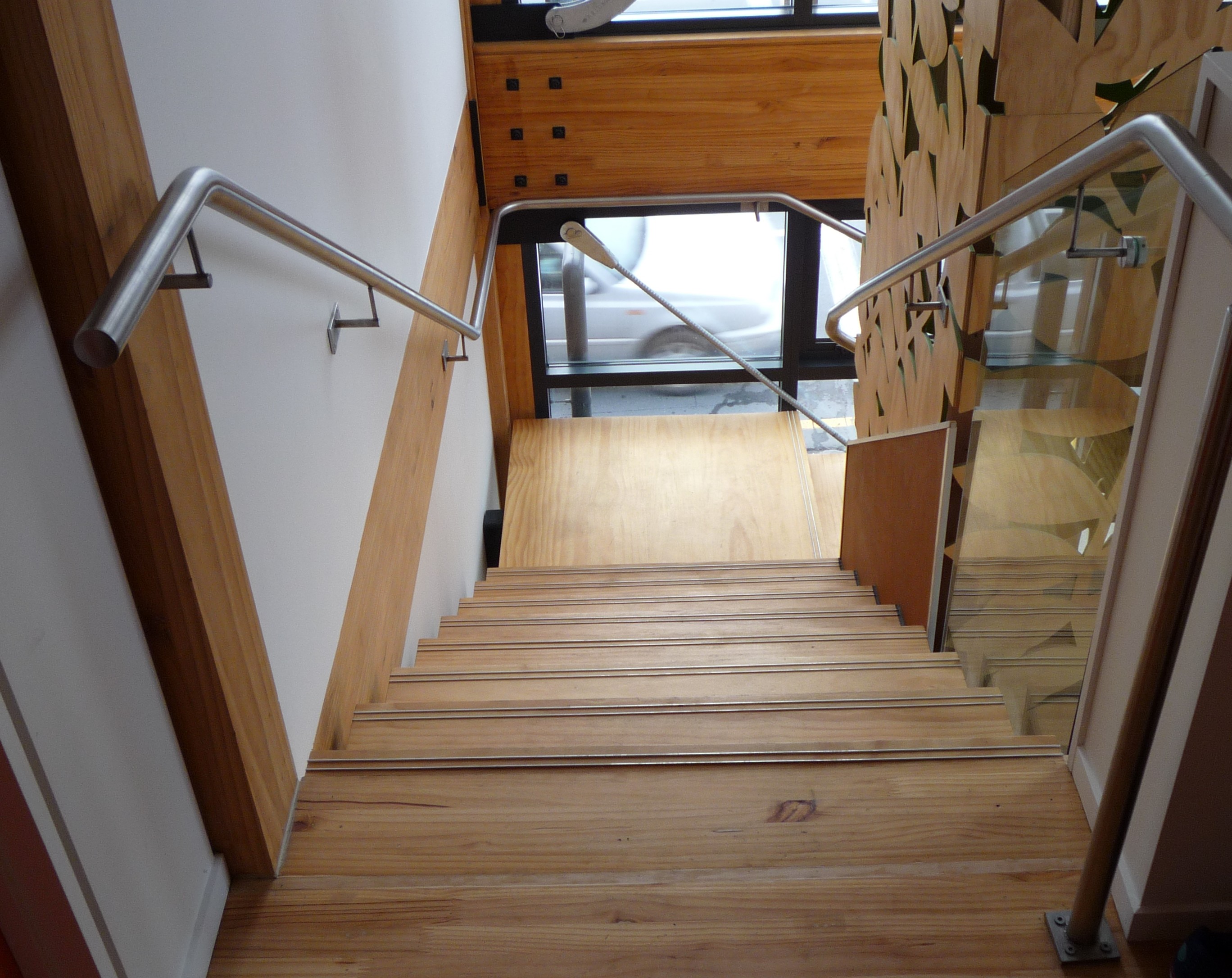 top view of timber stairs with steel handrails and glass balustrades