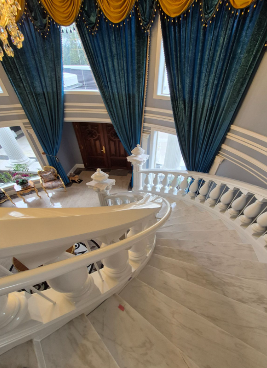 View of grand curved floating staircase going down