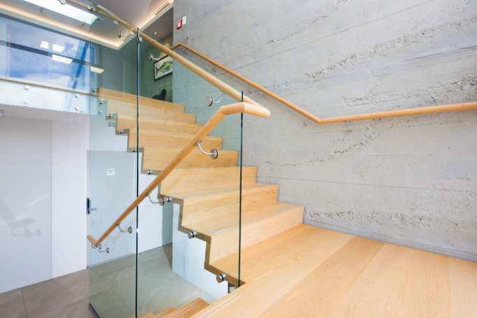 Timber stairs with glass balustrades and wooden railings