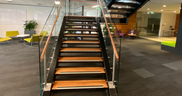 Office stairs with timber treads and glass balustrades