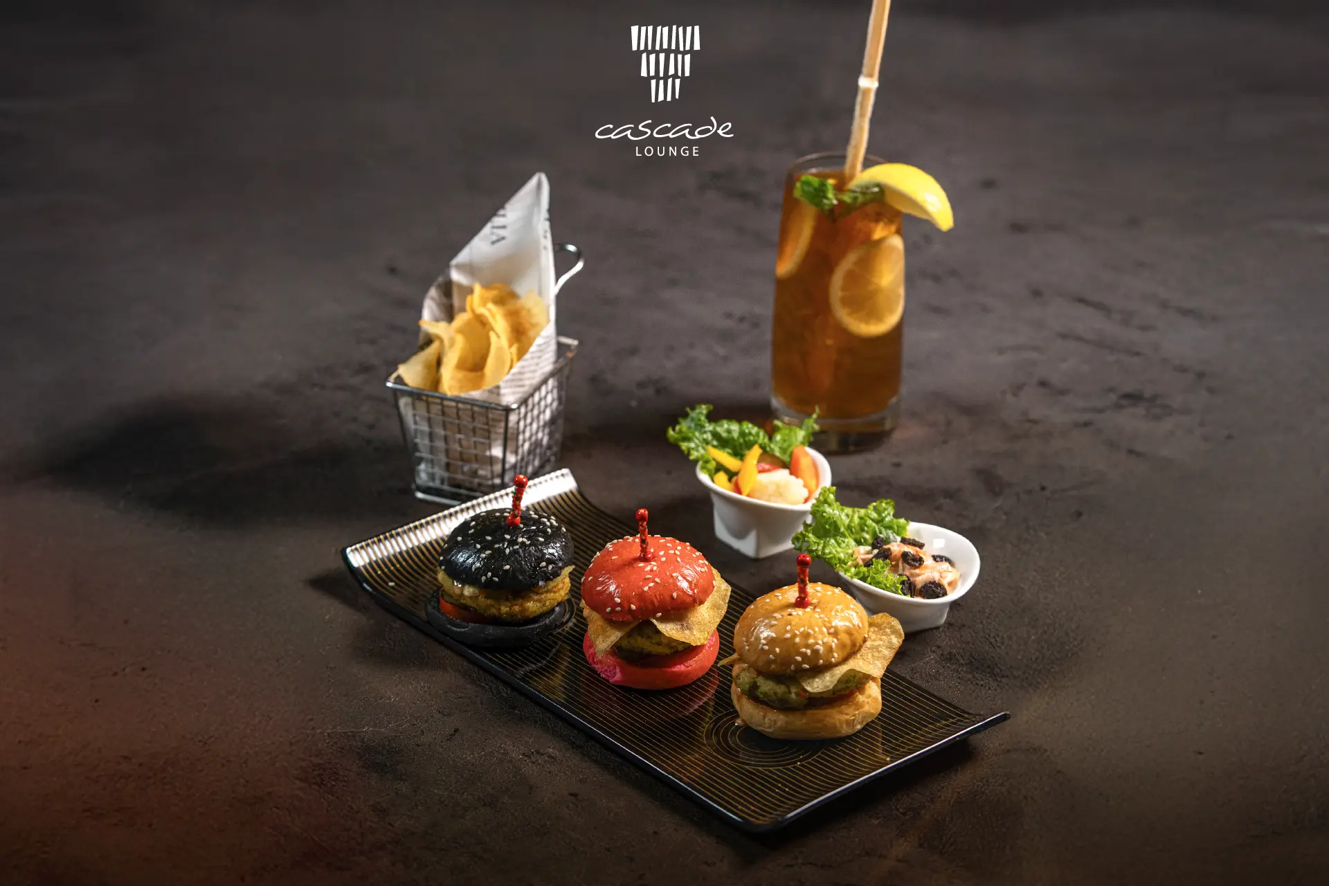 Three gourmet sliders with chips and iced tea at Cascade Lounge, Hotel Mulia Senayan Jakarta.