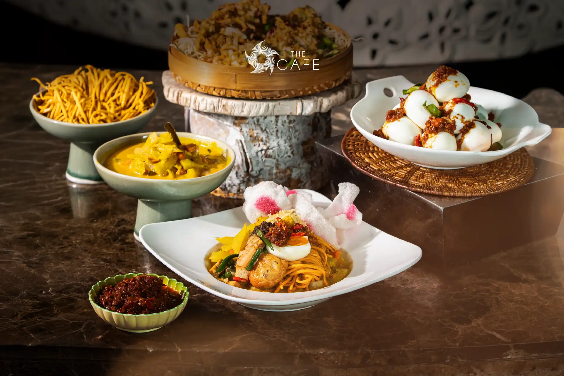 Lontong Medan at The Cafe, featuring rice cakes served with rich coconut curry, traditional accompaniments, and authentic Medanese flavours. Meta Description