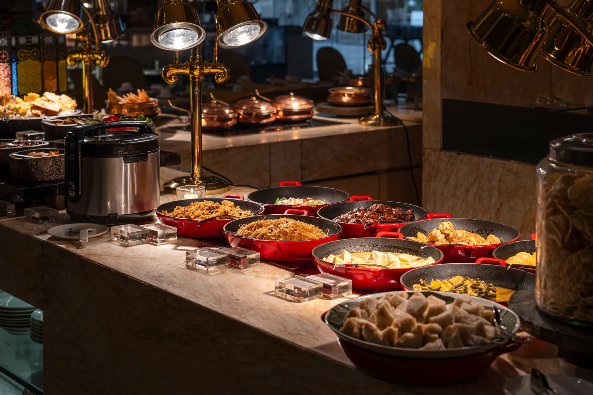Guests exploring the international buffet stations at The Cafe, Mulia Bali