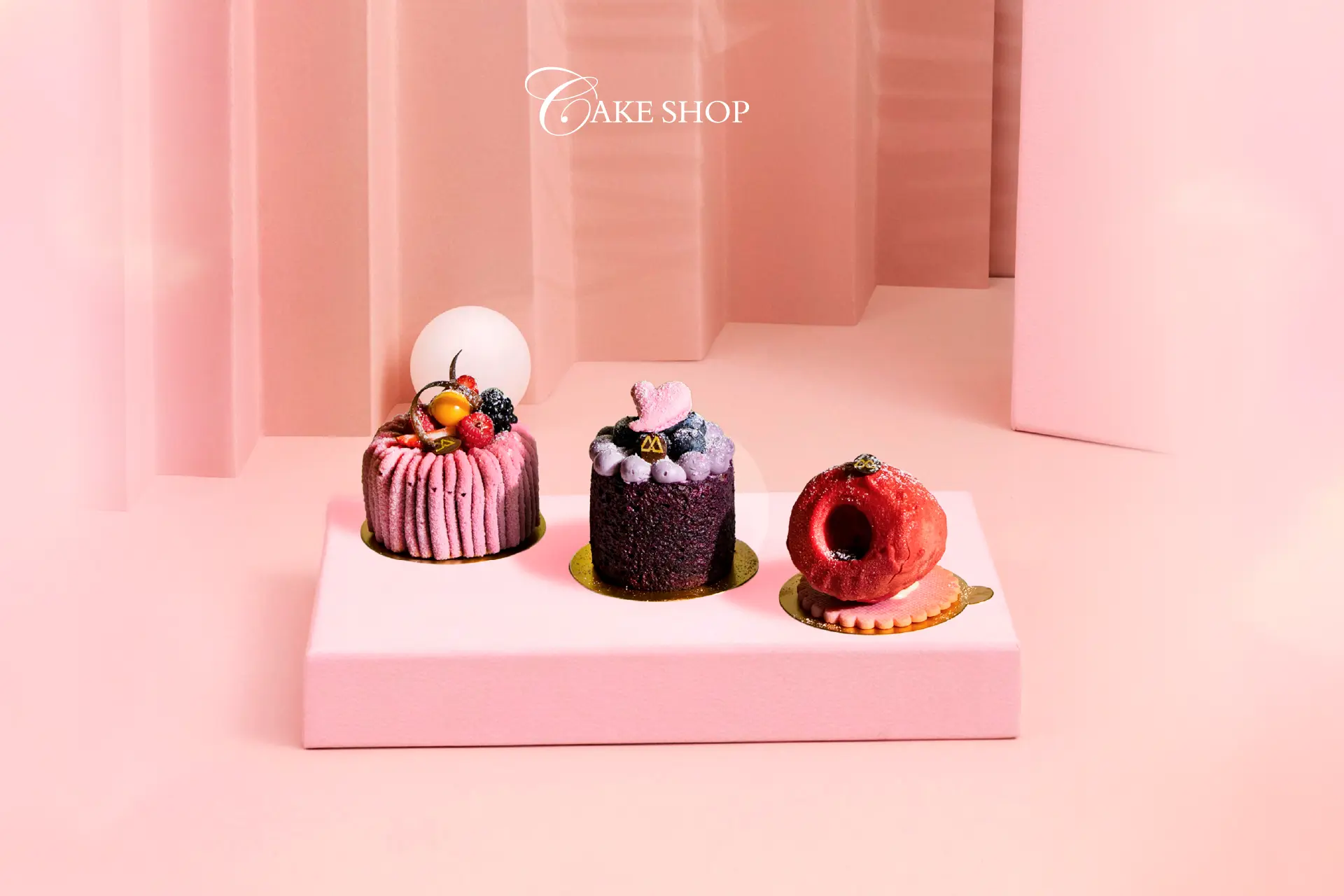 October in Bloom signature cakes from Cake Shop at Hotel Mulia Senayan, featuring three elegantly decorated cakes in pink, purple and red.